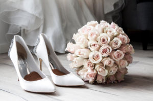 a pair of white shoes and flowers